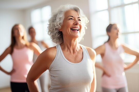 Middle-aged woman standing in a fitness studio, candidly expressing their active lifestyle through sport with friends.