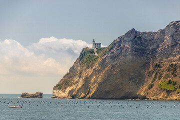 Fototapeta na wymiar Cape Miseno with its lighthouse in Pozzuoli gulf