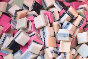 Square sugar candies, close-up, backdrop.