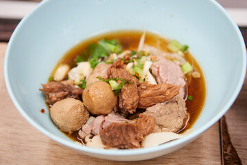 Rice stick noodles with braised beef and meatball in a bowl