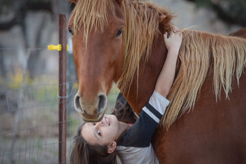 Young Girl Hugging From Red Horse