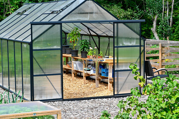 Green house in cultivating area in garden