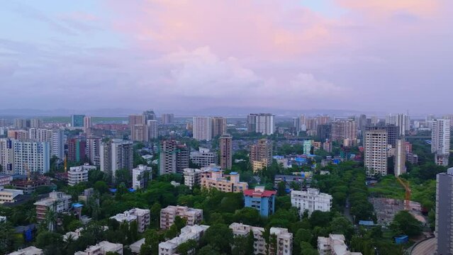 Aerial view of Mumbai City, Maharashtra, India. Cinematic dolly in drone shot of Mumbai skyline, beautiful cloudy weather during monsoon revealing cityscape. Roof top view of busy Asian city. 