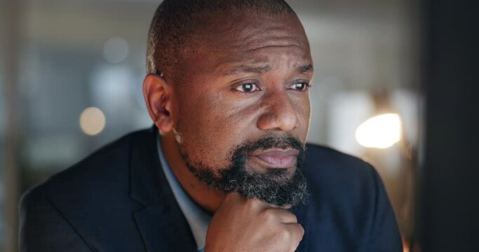 Reading, thinking and black man at computer in office with email, report or web review at night. Research, brainstorming ideas and business insight at overtime and businessman checking online article