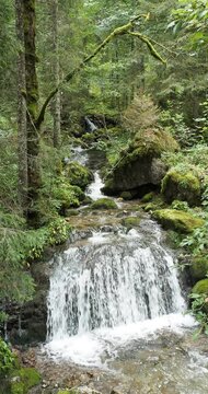 The Schiffbach in Upper Bavaria flows noisily in cascades between rocks and dense vegetation of Alpine forest from Rottachalm to Sibli-Waterfall, Rottach-Waterfall and Rottach river
