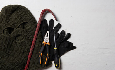 Beige knitted balaclava, gloves,screwdriver and Crowbar,Collection of tools and equipment for...