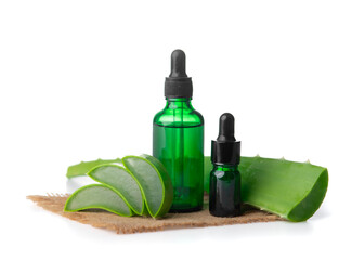 Aloe vera oil in glass bottle with sliced of aloe vera gel and leaves on white background.