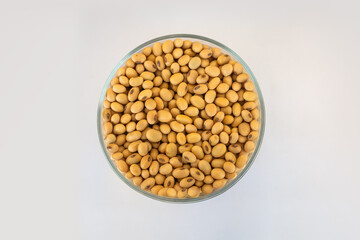 dry seeds in plate on white background view from above. grain crops, soy