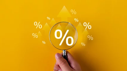 Fotobehang Interest rate and dividend concept. magnifying glasses and percentage symbols and an up arrow, interest rates continue to increase, and return on stocks and mutual funds. on yellow background © FAMILY STOCK