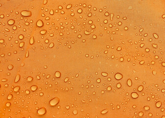 Orange fabric texture with water drops. Waterproof fabric