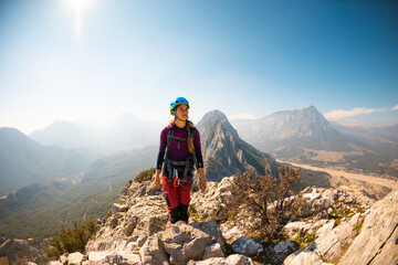 hiking in the mountains. a girl with a backpack walks along a mountain range. climbing and hiking.