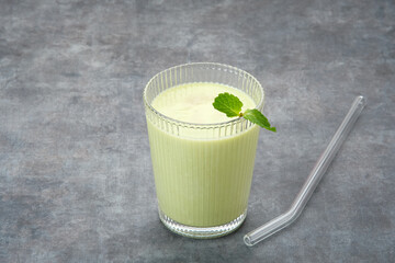 Jus Alpukat or Avocado Juice. Served in glass on dark background. 

