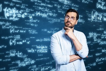 Attractive thoughtful young european businessman with glowing digital math formulas hologram on blurry background. Ai and statistics, education concept.