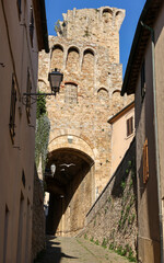 Steep and narrow street in old town of Massa Marittima, Italy