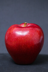 red apple on black background