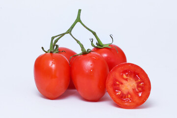Bunch of red cherry tomatoes with a white background