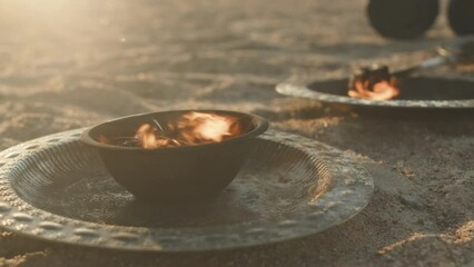 No people shot of fire in iron bowl on sandy windy beach at sunset used for outdoor circus fire showNo people shot of fire in iron bowl on sandy windy beach at sunset used for outdoor circus fire show