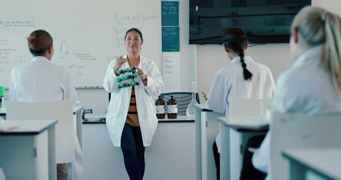 Science, molecules and an asian woman professor teaching class in a laboratory for innovation. School, learning or study in a classroom with a teacher or scientist holding a molecular structure model