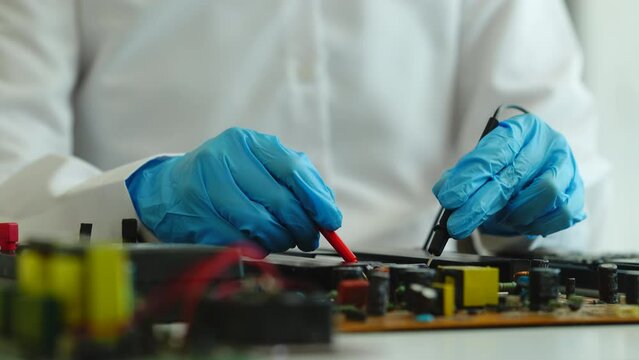 Skilled technician repairing a complex circuit board.