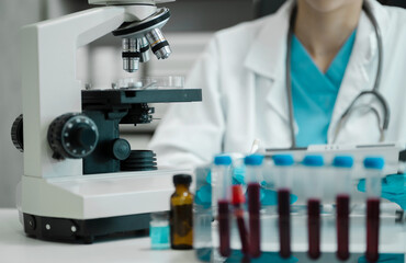 Fototapeta premium Chemist scientist holding tablet analyzing samples conducting experiment in laboratory with equipment, science concept.