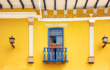 Street view of the old facade of a colonial building, Cuenca, Ecuador. - 643935862