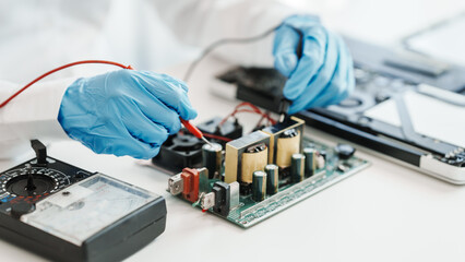 Skilled technician repairing a complex circuit board.