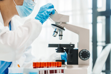 Close up scientist conducting precise virus lab test, scientific methodology, microbiologist...