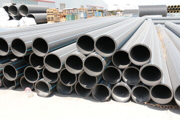 PE pipe plant, Industrial PE pipes with blue line for gas and water. HDPE pipe, Polyethylene PE100 pipe. Polyethylene pipe plant