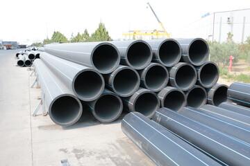 PE pipe plant, Industrial PE pipes with blue line for gas and water. HDPE pipe, Polyethylene PE100 pipe. Polyethylene pipe plant