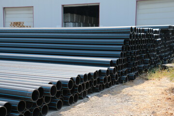 PE pipe plant, Industrial PE pipes with blue line for gas and water. HDPE pipe, Polyethylene PE100 pipe. Polyethylene pipe plant