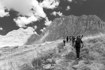 Fototapeta na wymiar Durmitor National Park, hikers on the trail to Mount Bobotov Kuk. black and white panorama. Montenegro (Crna Gora)