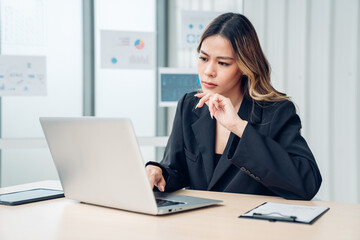 Successful asian businesswoman working and looking camera at her office desk, Concept of business risk analysis and assessment