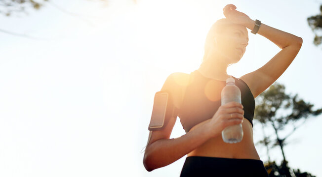 Nature mockup, running or woman drinking water in park after training, workout or exercise to hydrate. Sunshine, fitness space or tired girl with bottle for healthy liquid hydration on resting break