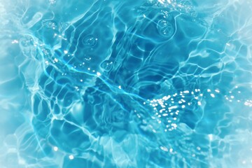 Obraz premium Blue water with ripples on the surface. Defocus blurred transparent blue colored clear calm water surface texture with splashes and bubbles. Water waves with shining pattern texture background.