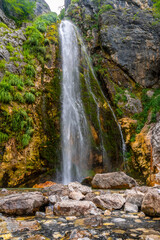 Obraz premium The Grunas waterfall of Theth national park in summer from below, Albania. Albanian alps