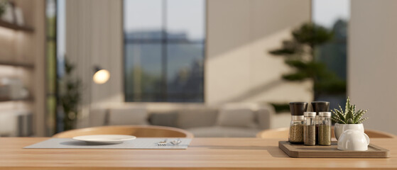 A seasoning bottle tray and a plate and cutlery on a placemat on a hardwood dining table