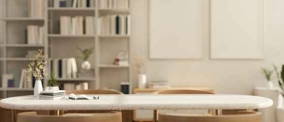 Empty space on a table in a cozy Scandinavian white living room with a bookshelf in the background.