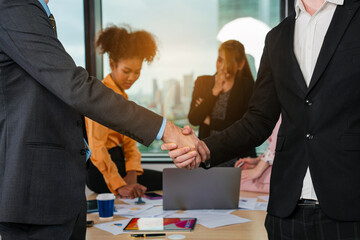 Shot crop of business people shaking hands inside office, Business meeting and partnership concepts.