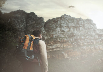 Hiking, man and ufo at mountains, spaceship or mystery adventure in countryside to travel....