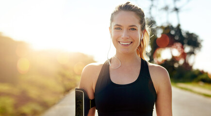 Fitness, portrait and happy woman with earphones outdoor on road at sunrise, training workout or...