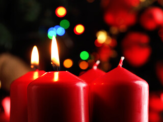 Red Advent candles with decoration in a dark room
