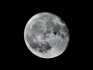 Fighter jet making a night flight on a full moon