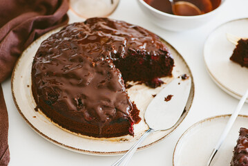 Delicious chocolate cake brownie with cherries on white wooden table