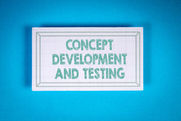 CONCEPT DEVELOPMENT AND TESTING. Cardboard sticker on a blue background