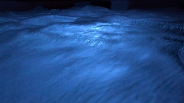 Still night video of blue illuminated clear water in jacuzzi creating a relaxing effect
