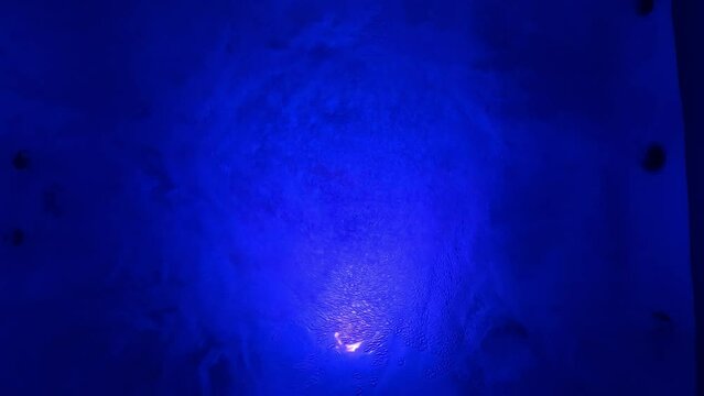 Still night video of blue illuminated clear water in jacuzzi creating a relaxing effect