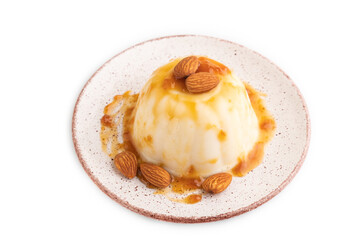 White milk jelly with caramel sauce isolated on white, side view.