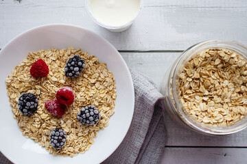 Oatmeal with berries. wooden on a white background. Breakfast