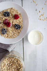 Oatmeal with berries. wooden on a white background. Breakfast