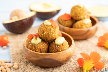Falafel with guacamole on blue wooden. Side view, selective focus.